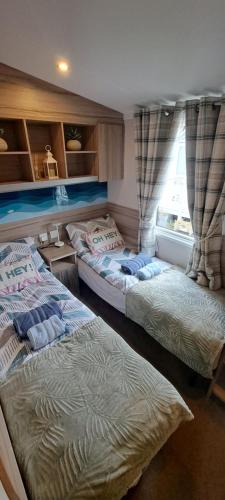 a bedroom with two beds and a window at Sea view holiday home with accessible ramp and WiFi in Port Seton