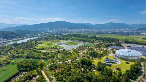 an aerial view of a park with a city at Shilla Stay Yeosu Expo Station in Yeosu