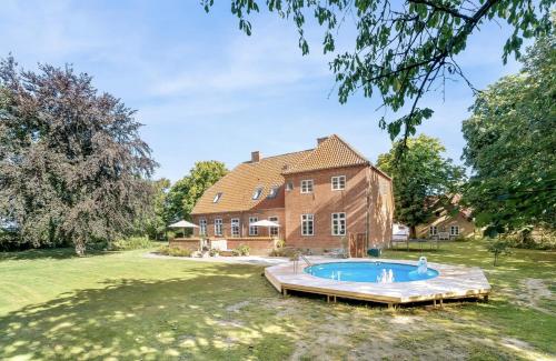 an estate with a pool in front of a house at Large Holiday Home With Pool On South Lolland Coast in Dannemare