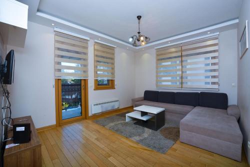 a living room with a couch and a table at Vila Mina in Zlatibor