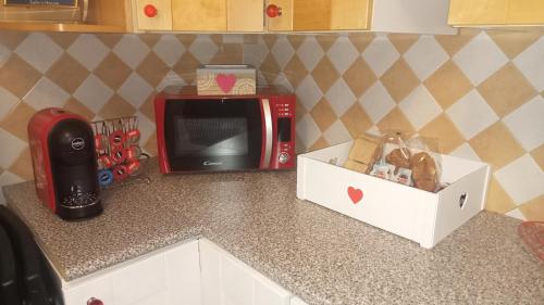 a kitchen counter with a microwave and a box of bread at Sally's House in Venaria Reale