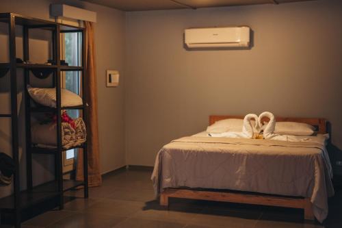 a bedroom with a bed with towels on it at The Wind Farm in Dahab