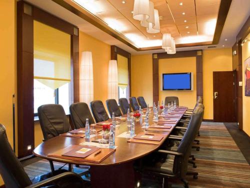 a large conference room with a long table and chairs at Sofitel Algiers Hamma Garden in Alger