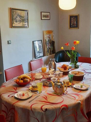 a table with a table cloth with food on it at A la fermette de Limesle in La Douaire