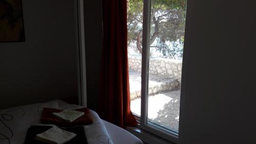 a bedroom with a window looking out at a yard at Holiday Home Villa Venta in Trogir
