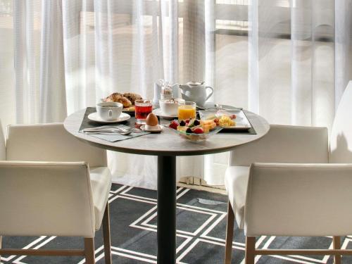 a table with a tray of food and drinks on it at Mercure Montpellier Centre Antigone in Montpellier