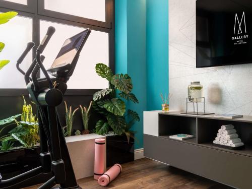 a room with potted plants and a treadmill at Cerretani Hotel Firenze - MGallery Collection in Florence