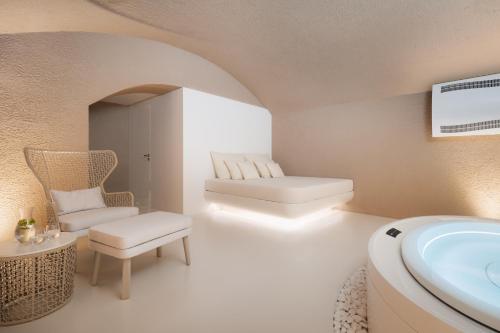 a bathroom with a sink and a couch and a chair at EA Hotel Sonata in Prague