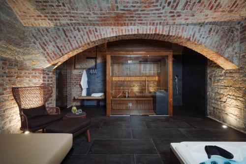 a room with a brick wall and an archway at EA Hotel Sonata in Prague