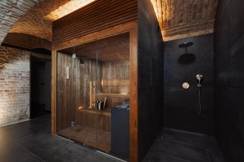 a bathroom with a shower with wooden walls at EA Hotel Sonata in Prague