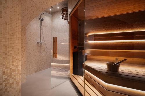 a bathroom with a shower with a glass door at EA Hotel Sonata in Prague