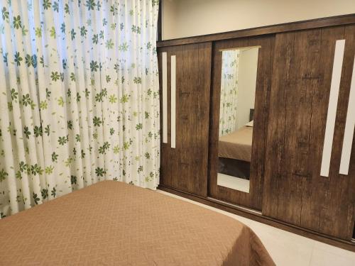 a bedroom with a bed and a large mirror at 3BR Furnished Apartment for Rent - PART OF VILLA in Amman