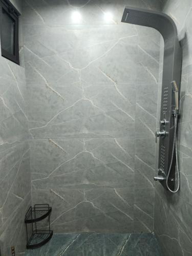 a bathroom with a shower with a stone wall at 3BR Furnished Apartment for Rent - PART OF VILLA in Amman