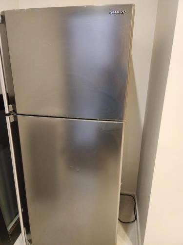 a stainless steel refrigerator in a kitchen at 3BR Furnished Apartment for Rent - PART OF VILLA in Amman