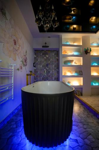 a bath tub in a room with lights at The Victorian Hotel & Spa Room 1 in Yerevan