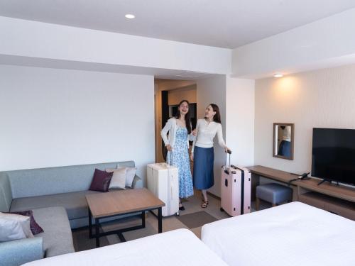 two women are standing in a hotel room at Tokyu Stay Aoyama Premier in Tokyo