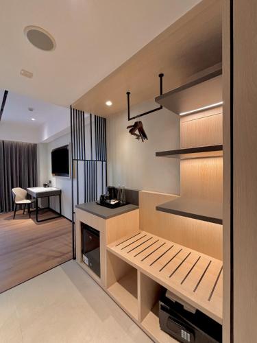 a room with a kitchen and a dining room at FortunaSuites Malioboro Yogyakarta in Sentool