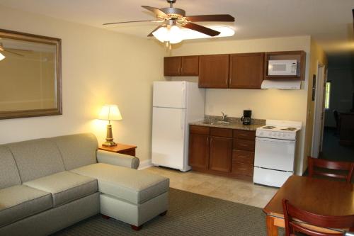 a living room with a couch and a kitchen at Affordable Suites of America Augusta in Augusta