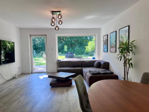 a living room with a couch and a table at Large Munich house with 4 bedrooms in a quiet and greened villa area near Munich in Munich