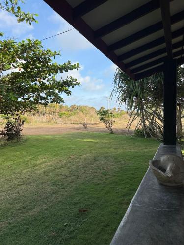 a view of a field from the porch of a house at The Beach House Kalpitiya in Puttalam