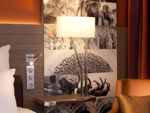 a lamp on a table in a hotel room at Mercure Chambéry Centre in Chambéry