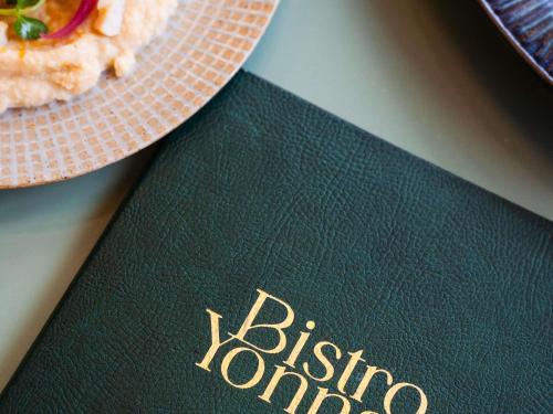 a plate of pizza sitting on top of a passport at Mercure La Roche Sur Yon in La Roche-sur-Yon