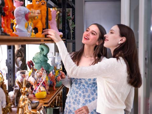 two women are looking at a display of toys at Tokyu Stay Aoyama Premier in Tokyo
