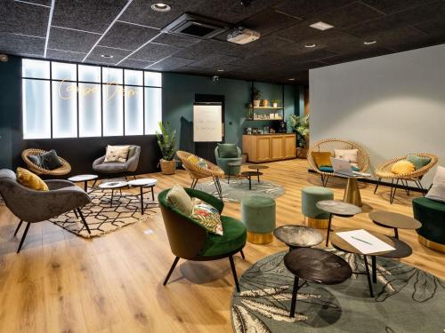 a furniture store with chairs and tables and chairs at Mercure La Roche Sur Yon in La Roche-sur-Yon