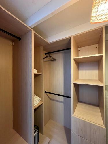 a walk in closet with wooden shelves and a ceiling at Le Nid in Nantes