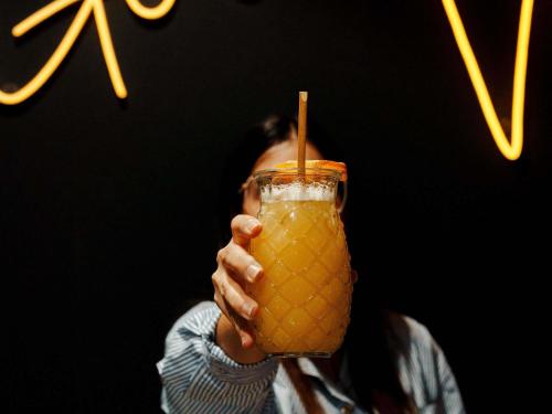 a person holding up a drink with a straw at Mercure La Roche Sur Yon in La Roche-sur-Yon