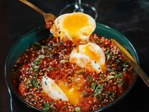 a bowl of food with an egg on top at Mercure La Roche Sur Yon in La Roche-sur-Yon