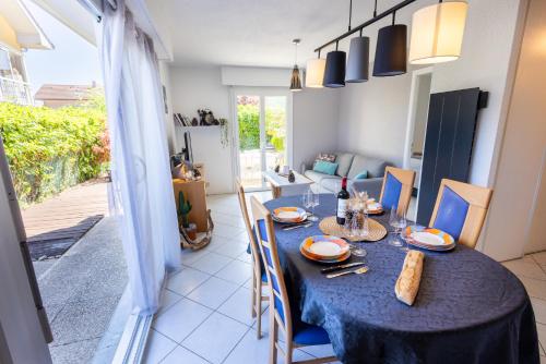 a dining room with a blue table and chairs at LE LEMAN - 5 min à pieds du lac, des plages, des parcs in Publier