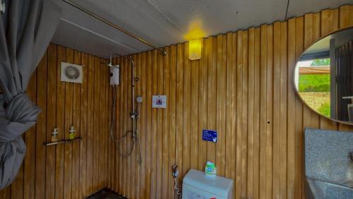 a wood paneled bathroom with a shower and a toilet at The X10 Nordic Tent and Glamping Pool Villa Khaoyai เขาใหญ่ - SHA Certified in Ban Thung Sawang