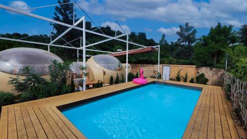 a swimming pool in a garden with domes at The X10 Nordic Tent and Glamping Pool Villa Khaoyai เขาใหญ่ - SHA Certified in Ban Thung Sawang