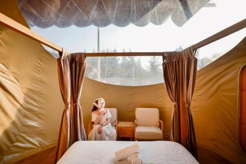 a woman sitting in a chair in a tent at The X10 Nordic Tent and Glamping Pool Villa Khaoyai เขาใหญ่ - SHA Certified in Ban Thung Sawang