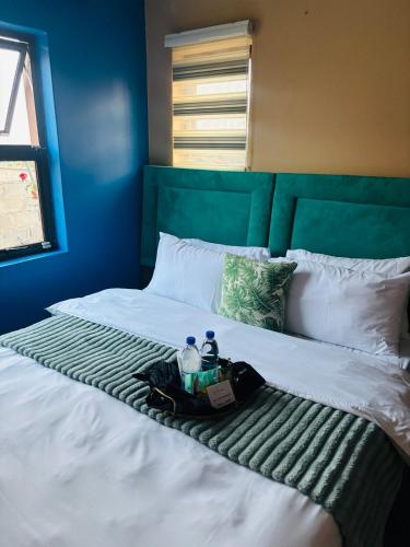 a bed with two people sitting on top of it at Tubungu- House of Lux& Lush in Matsapha
