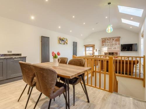 a kitchen and dining room with a wooden table and chairs at 2 Bed in Dalston 93820 in Dalston