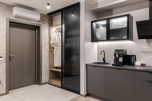 a kitchen with a black door and a closet at Rest&Ski Spa Resort in Bukovel