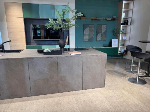 a lobby with a counter with a vase with flowers on it at Mountain Lodge Obergurgl Ski In Chalet, opening Dec 25 