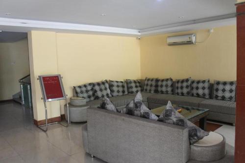 a living room with a couch and a table at Hotel tathagat bodhgaya near main temple in Bodh Gaya