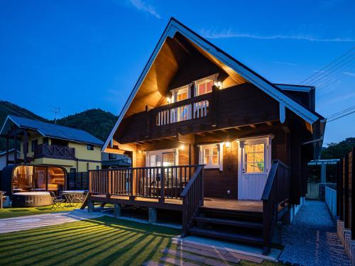 a house with a porch and a deck at Villa & Sauna - NAGIOTO - in Kure