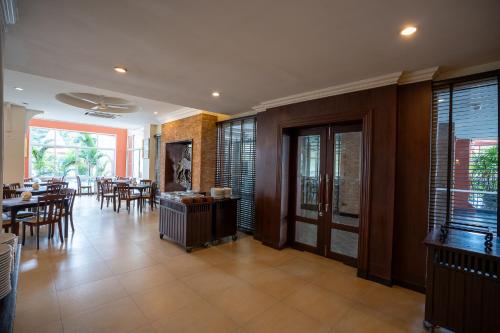 a dining room with tables and chairs in a house at Sunday Chateau En Ville - Pattaya in North Pattaya