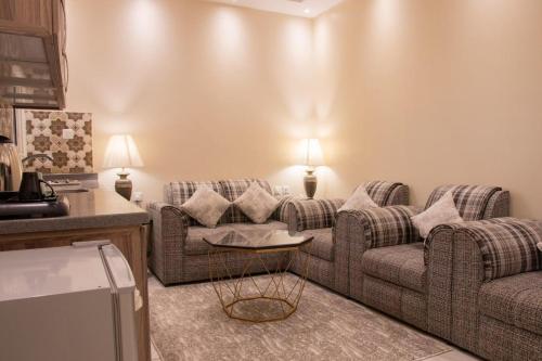 a living room with two couches and a table at شقق فينا in Khamis Mushayt