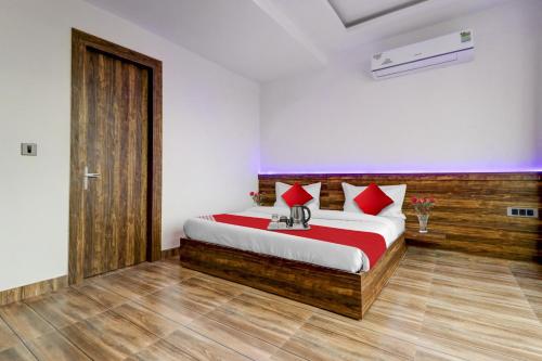 ein Schlafzimmer mit einem Bett mit roten Kissen in der Unterkunft Hotel O Times Square in Indraprast