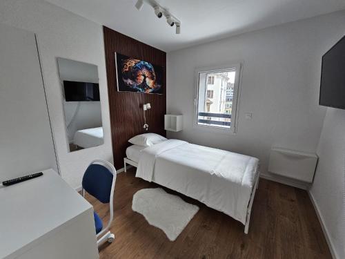 a small bedroom with a bed and a window at Cosy private room in Lausanne center in Lausanne