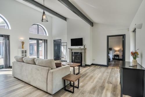 a living room with a couch and a fireplace at The Annex in Wimborne Minster