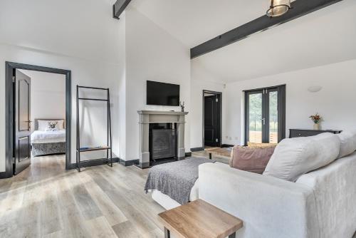 a living room with a white couch and a fireplace at The Annex in Wimborne Minster
