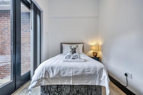 a bedroom with a bed and a large window at The Annex in Wimborne Minster