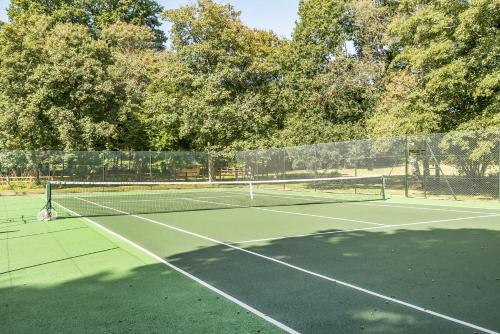 a tennis court with two tennis nets on it at The Annex in Wimborne Minster