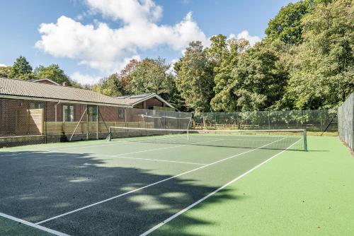 a tennis court in front of a building at The Annex in Wimborne Minster